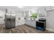Bright kitchen with white cabinets, modern appliances, stainless steel fridge and hardwood floors at 7860 Henry Harris Rd, Fort Mill, SC 29707
