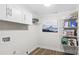 Cozy laundry room with ample storage shelving, wood look flooring, and neutral paint at 7860 Henry Harris Rd, Fort Mill, SC 29707