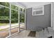 Cozy screened in back patio with brick walls and access to the backyard at 7860 Henry Harris Rd, Fort Mill, SC 29707