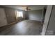 Well-lit living room boasts modern floors and a window at 824 S Laurel St, Lincolnton, NC 28092