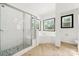Bright bathroom with white tile, a glass shower, herringbone floors, and a separate soaking tub at 862 Kathy Dianne Dr, Fort Mill, SC 29707