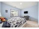 Cozy bedroom featuring light blue walls, carpet floors, natural light, and a comfortable chair at 862 Kathy Dianne Dr, Fort Mill, SC 29707