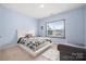 A bright bedroom with a queen bed, a seating chair, and a view from the window at 862 Kathy Dianne Dr, Fort Mill, SC 29707