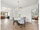 Formal dining area showcases a modern chandelier, wainscoting and designer wallpaper at 862 Kathy Dianne Dr, Fort Mill, SC 29707