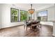 A dining room with natural light from large windows and a modern chandelier over the dining table at 862 Kathy Dianne Dr, Fort Mill, SC 29707