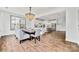 A dining room with hardwood floors, a modern chandelier, a table, and a view into the kitchen at 862 Kathy Dianne Dr, Fort Mill, SC 29707