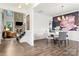 Spacious dining area with dark wood floors, stylish decor, and an adjacent stone fireplace at 862 Kathy Dianne Dr, Fort Mill, SC 29707