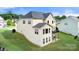 Back exterior view of home featuring wooden deck, patio, green grass, and gray roof at 862 Kathy Dianne Dr, Fort Mill, SC 29707