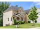 Charming home showcasing a mix of stone and siding, a covered porch, and lush greenery at 862 Kathy Dianne Dr, Fort Mill, SC 29707