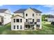 Back exterior view of home featuring wooden deck, patio, green grass, and gray roof at 862 Kathy Dianne Dr, Fort Mill, SC 29707