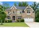 Beautiful brick home boasts stone accents, an attached two-car garage, and well-maintained landscaping at 862 Kathy Dianne Dr, Fort Mill, SC 29707