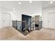 Upstairs hallway with modern railing overlooking a stone fireplace and dramatic black accent wall at 862 Kathy Dianne Dr, Fort Mill, SC 29707