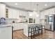Stylish kitchen featuring stainless steel appliances, white cabinetry, and a marble countertop island at 862 Kathy Dianne Dr, Fort Mill, SC 29707