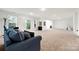 Spacious living room featuring neutral carpet, couch, large windows, and access to the backyard at 862 Kathy Dianne Dr, Fort Mill, SC 29707