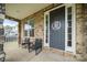 Inviting porch with chairs and a dark front door with sidelights at 862 Kathy Dianne Dr, Fort Mill, SC 29707
