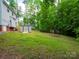 A spacious backyard featuring mature trees and a storage shed at 8905 Vagabond Rd, Mint Hill, NC 28227
