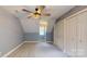 Spacious bedroom with neutral tones, carpet, and natural light, featuring dual closets and fan at 8905 Vagabond Rd, Mint Hill, NC 28227