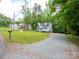 Charming home with lush greenery and a long driveway leading to the property at 8905 Vagabond Rd, Mint Hill, NC 28227