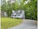 A charming two-story home with a well-maintained lawn and mature trees at 8905 Vagabond Rd, Mint Hill, NC 28227