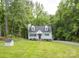 Charming two-story home featuring a well-manicured lawn and mature trees at 8905 Vagabond Rd, Mint Hill, NC 28227