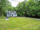 Charming two-story home featuring a well-manicured lawn and mature trees at 8905 Vagabond Rd, Mint Hill, NC 28227