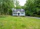Charming two-story home featuring a well-manicured lawn and mature trees at 8905 Vagabond Rd, Mint Hill, NC 28227