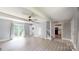 Bright and airy living room with new flooring, neutral walls, ceiling fan, and sliding glass doors leading outside at 8905 Vagabond Rd, Mint Hill, NC 28227