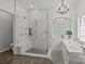 Beautiful bathroom featuring a glass shower, soaking tub, stylish chandelier, and modern fixtures at 9625 Donna Ve Ln, Charlotte, NC 28277
