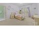 Charming bedroom features a four-poster bed, lilac accents, floral decorations, and a bright window at 9625 Donna Ve Ln, Charlotte, NC 28277
