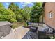 Outdoor deck features a grill, patio furniture, and wooded view at 9625 Donna Ve Ln, Charlotte, NC 28277