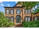 Brick two-story home with black trim, arched windows, and manicured landscaping at 9625 Donna Ve Ln, Charlotte, NC 28277