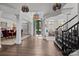 Stately foyer with hardwood floors, pillars, and grand staircase at 9625 Donna Ve Ln, Charlotte, NC 28277