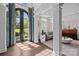 Grand foyer with hardwood floors, pillars, and a view into the living room at 9625 Donna Ve Ln, Charlotte, NC 28277