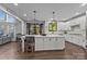 Bright, open kitchen featuring white cabinets, a large center island, and modern pendant lighting at 9625 Donna Ve Ln, Charlotte, NC 28277
