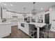 Bright kitchen features white cabinets, marble countertops, and a large island with seating for four at 9625 Donna Ve Ln, Charlotte, NC 28277
