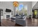 Open-concept living room with a fireplace, large windows, and comfortable seating at 9625 Donna Ve Ln, Charlotte, NC 28277