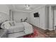 Main bedroom with hardwood floors and custom built-in storage around a wall-mounted TV at 9625 Donna Ve Ln, Charlotte, NC 28277