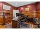 This home office features wood paneling, a rug, and dark wood furniture at 9625 Donna Ve Ln, Charlotte, NC 28277