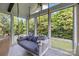 Screened in porch features an outdoor swing and wooded backyard views at 9625 Donna Ve Ln, Charlotte, NC 28277