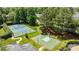 Overhead view of tennis court and basketball court surrounded by lush greenery and mature trees at 9625 Donna Ve Ln, Charlotte, NC 28277
