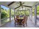Cozy sunroom with wood-framed windows providing natural light and a tranquil view of surrounding trees at 9625 Donna Ve Ln, Charlotte, NC 28277