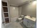 The bathroom features a shower and tub combination, tiled floors, shelving, a toilet, and a vanity at 103 Meadow Ne Ave # 6, Concord, NC 28025