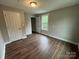 This bedroom features hardwood floors, two windows, a closet, and neutral paint at 103 Meadow Ne Ave # 6, Concord, NC 28025