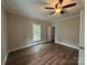 Bright bedroom with hardwood floors, a ceiling fan, and a window at 103 Meadow Ne Ave # 6, Concord, NC 28025