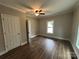 Spacious bedroom featuring hardwood floors and a window at 103 Meadow Ne Ave # 6, Concord, NC 28025