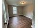 This bedroom features hardwood floors, a window, neutral walls, and great natural light at 103 Meadow Ne Ave # 6, Concord, NC 28025