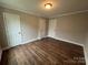 Bedroom featuring hardwood floors and three doors at 103 Meadow Ne Ave # 6, Concord, NC 28025