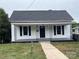 Charming single-story home with a covered front porch and a well-maintained lawn at 103 Meadow Ne Ave # 6, Concord, NC 28025