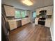 This is a spacious kitchen with white cabinets, modern appliances, and hardwood floors at 103 Meadow Ne Ave # 6, Concord, NC 28025