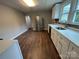 This kitchen has new stainless steel appliances, white cabinets, and hardwood floors at 103 Meadow Ne Ave # 6, Concord, NC 28025